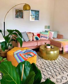 a living room filled with furniture and lots of plants