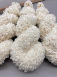 several white crocheted balls of yarn on a table