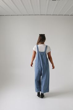 Frankie Denim Overalls are crafted from washed denim for a stylish, weathered look. Featuring an oversized and loose fit with adjustable straps and distressed details, these overalls are designed to provide a comfortable, personalized fit. Model Measurements: Hips 34” Waist 25” Bust 32” Height 5’6.5, wearing a size small Material: 100 Cotton Measurements XS: Hips: 42"| Length: 44" (taken from top of front of overalls to ankle cuff) S: Hips: 42"| Length: 44.5" (taken from top of front of overalls Bridesmaid Tops, Washed Denim, Denim Overalls, Romper Pants, New Arrival Dress, Trending Dresses, Denim Wash, Model Measurements, Sweater Top