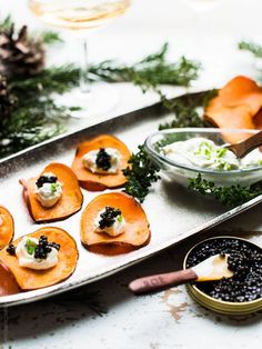 small appetizers are arranged on a metal tray