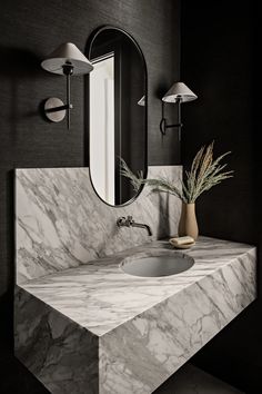 a bathroom with a marble sink and mirror