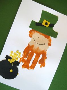 a child's handprint with a lepreite hat and pot of gold coins