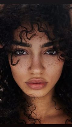 an image of a woman with freckles on her face and hair blowing in the wind