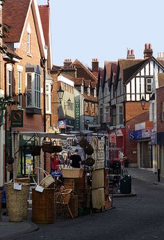 an empty street with shops and people walking on it