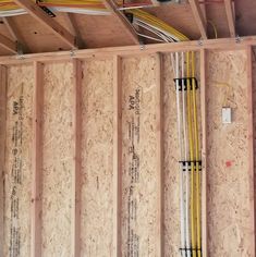 an unfinished room with electrical wiring and wires in the wall next to some wood framing