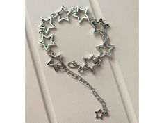 Our Y2K Star Charm Bracelet captures the playful spirit of the late '90s and early '00s with its chic star motifs and sleek metal craftsmanship. Perfect for anyone who loves adding a hint of sparkle and nostalgia to their look. Key Features Chic Star Charms: Each charm is shaped like a star, offering a whimsical yet elegant appeal that shines in any light. High-Quality Metal: Crafted from durable metal for a long-lasting finish that resists wear and tarnish. Adjustable Fit: Comes with an adjusta Star Charm Bracelet, Bracelet Star, Y2k Star, Jewelry Elegant, Link Chain Bracelet, Bracelet Women, Elegant Gifts, Late 90s, Star Jewelry