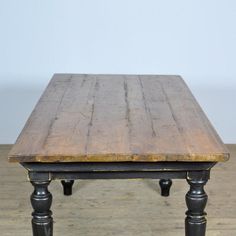 an old wooden table sitting on top of a hard wood floor