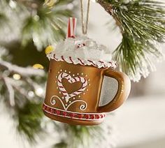 a mug ornament hanging from a christmas tree