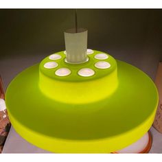 a green lamp sitting on top of a table