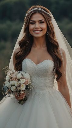 a woman in a wedding dress holding a bridal bouquet and smiling at the camera