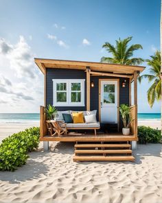 a tiny house on the beach with stairs leading up to it