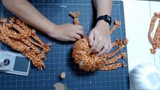 someone is crocheting yarn on a cutting board