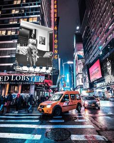 taxi cabs driving down a busy city street at night