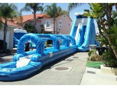 an inflatable water slide is on the driveway