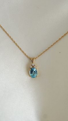 * Pendant Material: Blue Topaz, Diamond, 14k Yellow Gold  * Chain: 1.5MM, 16 Inch, Interweave Chain with Spring Lock * Pendant Dimensions: 0.75x 0.25Inch * Stone Weight & sizes: Blue Topaz - 2.30ct, Diamond - 0.15ct  * Overall weight: 3.3g Gold Topaz Necklace, Blue Topaz Necklace Simple, Blue Topaz Necklace Pendants, Blue Diamond Pendant, Blue Gem Jewelry, Blue Gold Necklace, Gold And Blue Necklace, 3 Stone Necklace, Yellow Topaz Necklace