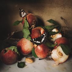 an arrangement of apples with butterflies on them