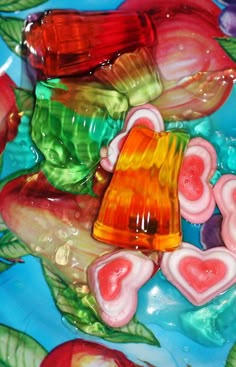 colorful gummy bears sitting on top of each other in the shape of heart shapes