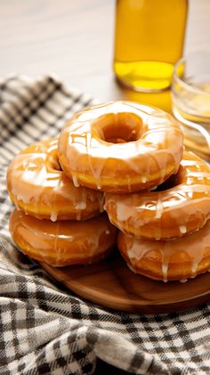 glazed donuts with icing on a wooden plate