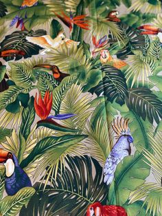 a colorful tropical print fabric with parrots and palm leaves on the bottom half of it