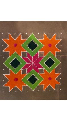 an artistic design on the ground in orange, green and pink colors with diamond shapes