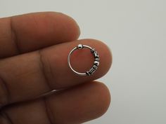 "Nose Hoop, Nose Ring, Hoop Earrings, Ethnic hoops, 22g (0.6mm) Cartilage Silver Small Bali Tribal Bead Hoop Black Piercing Ring 5/16\" (8mm) -------------------------------------------------- Sold individually / Single Piece / 1 Piece. Size: 22 gauge (0.6mm) thick in 5/16\" (8mm) diameter. Made with .925 Sterling Silver Suitable for Cartilage, Upper Ear, Ear Lobe, Helix, Nose Piercing -------------------------------------------------- Shipping Information: Items are shipped worldwide from Thail Nose Ring Silver Hoop, Adjustable Hoop Nose Rings, Adjustable Round Bohemian Nose Rings, Adjustable Hypoallergenic Small Hoop Septum Ring, Adjustable Hoop Septum Ring, Stackable, Adjustable Hoop Septum Ring, Adjustable Stackable Cartilage Earrings, Adjustable Stackable Small Hoop Cartilage Earrings, Adjustable Stackable Hoop Septum Ring