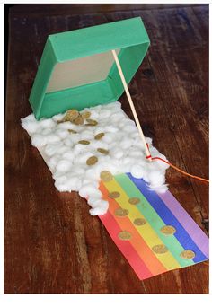 an open box with cotton and gold coins in it on top of a wooden table