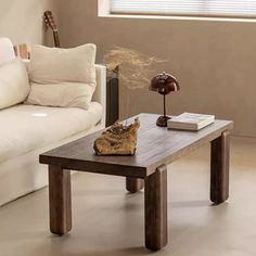 a living room with a white couch and wooden table