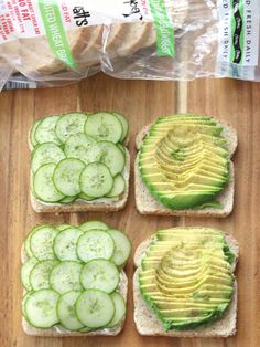 four slices of bread with cucumber and avocado on them