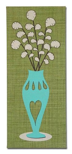 a blue vase filled with white flowers on top of a green tablecloth covered wall