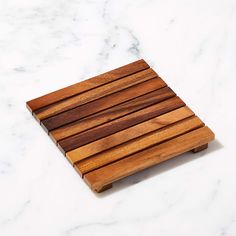 a wooden cutting board sitting on top of a white counter