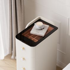 a small white table with a coffee cup on top