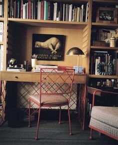 a desk with a chair and bookshelf full of books