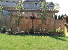 a wooden fence with flowers in the middle