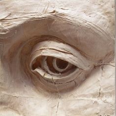 an eye carved into the side of a wall