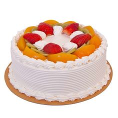 a white cake with fresh fruit on top