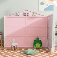 a child's room with a pink bed and green toy in front of it