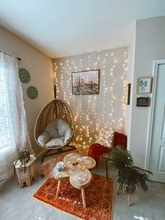 a living room filled with furniture and lights on the wall above it is a hanging hammock chair