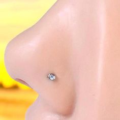 an image of a woman's breast with a diamond nose ring on her left side