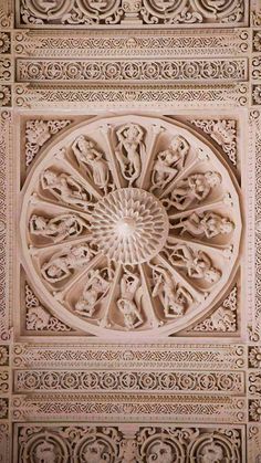 an intricately designed ceiling with carvings on it