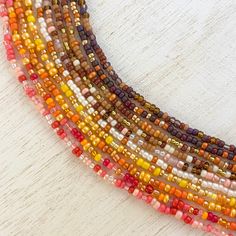 S e e d   B e a d   N e c k l a c e  Fall is upon us!  Colorful, dainty, Autumn-themed seed bead necklaces are perfect accessories for any outfit! Find your favorite color combos to mix and match and show off your style this cozy season.  Swipe all the way through to checkout the full collection!  > Colorful seed beads strung on thoroughly bonded bead weaving thread (this thread is NOT stretchy! While the thread is very strong and securely tied, please do not tug excessively on the necklace as this can weaken its strength over time)  > Lobster clasp for easy removal  > Comes with a 2 in. chain extender for easy adjustment  > For long lasting quality of this piece, please be mindful of wearing while in water or with excess lotions/oils.  Follow TheFreeSoulShop on Instagram for more! For a c Autumn Necklace Fall Jewelry, Fall Beaded Necklaces, Fall Beaded Jewelry, Pinterest Necklace, Fall Necklaces, Seed Bead Necklaces, Tiny Bead Bracelet, Fall Bead, Necklaces Ideas