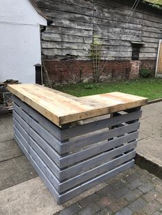 an outdoor bar made out of pallet wood