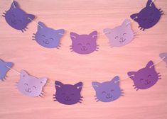 paper cut out cats hanging on a clothes line