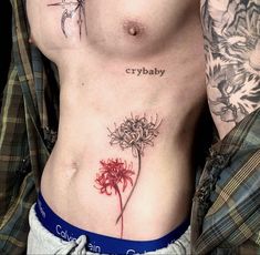 a close up of a person with tattoos on their stomachs and one has a flower