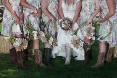 a group of women standing next to each other on top of a grass covered field