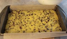 a casserole dish with cheese and raisins in it, ready to be baked