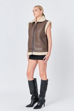 Bundle up in style with our Sherpa Lined Faux Leather Vest. Its oversized fit and belted design add a touch of edginess to any outfit. Featuring a front zipper closure and practical pockets, you'll stay warm and look chic. Hand wash cold to maintain its faux leather look. This versatile outerwear is perfect for layering and elevating your fashion game. Get the best of both worlds with our Sherpa Lined Faux Leather Vest - luxurious and affordable. Shop now for your new go-to piece that will keep Knitwear Trends, Jumpsuit Fall, Knit Loungewear, Faux Leather Vest, Strapless Bodycon Dress, Blazer And Shorts, Geek Chic, Leather Dresses, Leather Vest