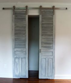 an open door with shutters on the inside