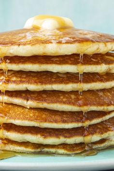 a stack of pancakes covered in syrup and butter