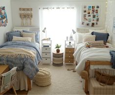 a bedroom with two beds, a desk and pictures on the wall above it in front of a window