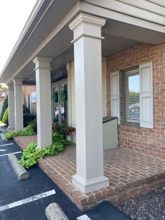 an outside view of a brick building with white columns